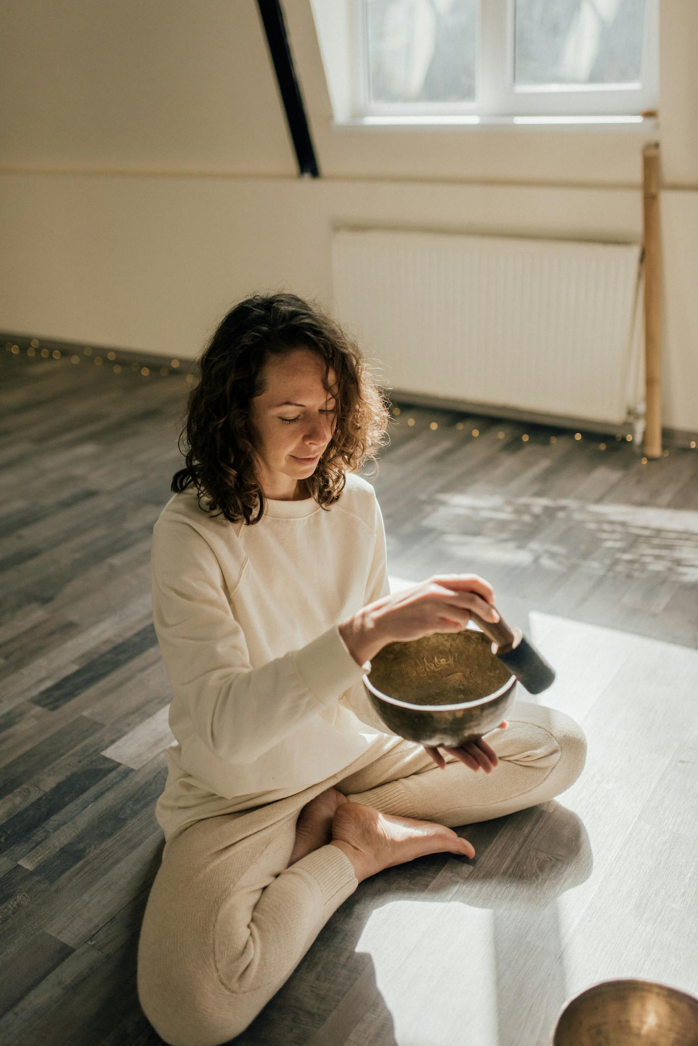Relaxing indoor meditation with a Tibetan singing bowl, capturing serene atmosphere.